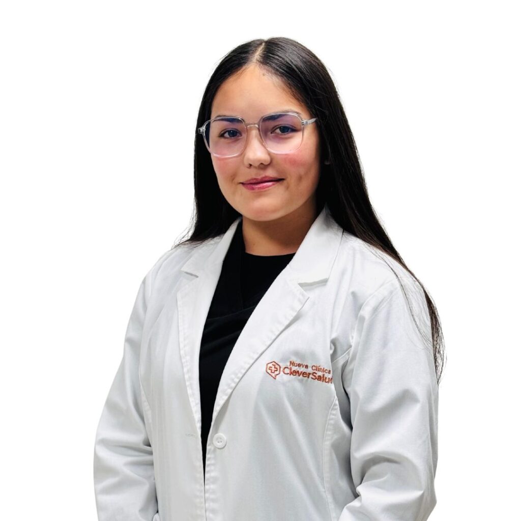Portrait of a female healthcare professional with long dark hair and glasses, wearing a white lab coat and a black top, smiling against a white background.