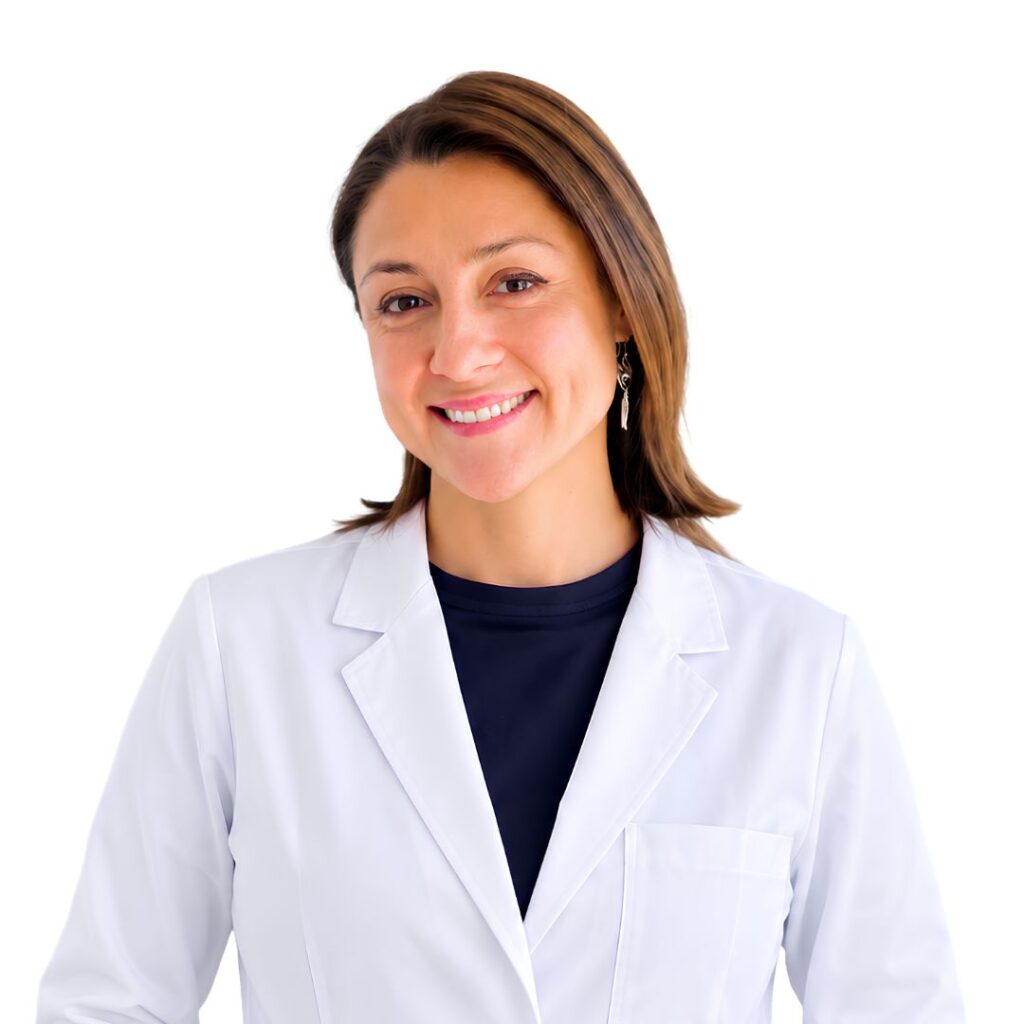 Smiling woman in a white lab coat, navy shirt, posing for a professional portrait.