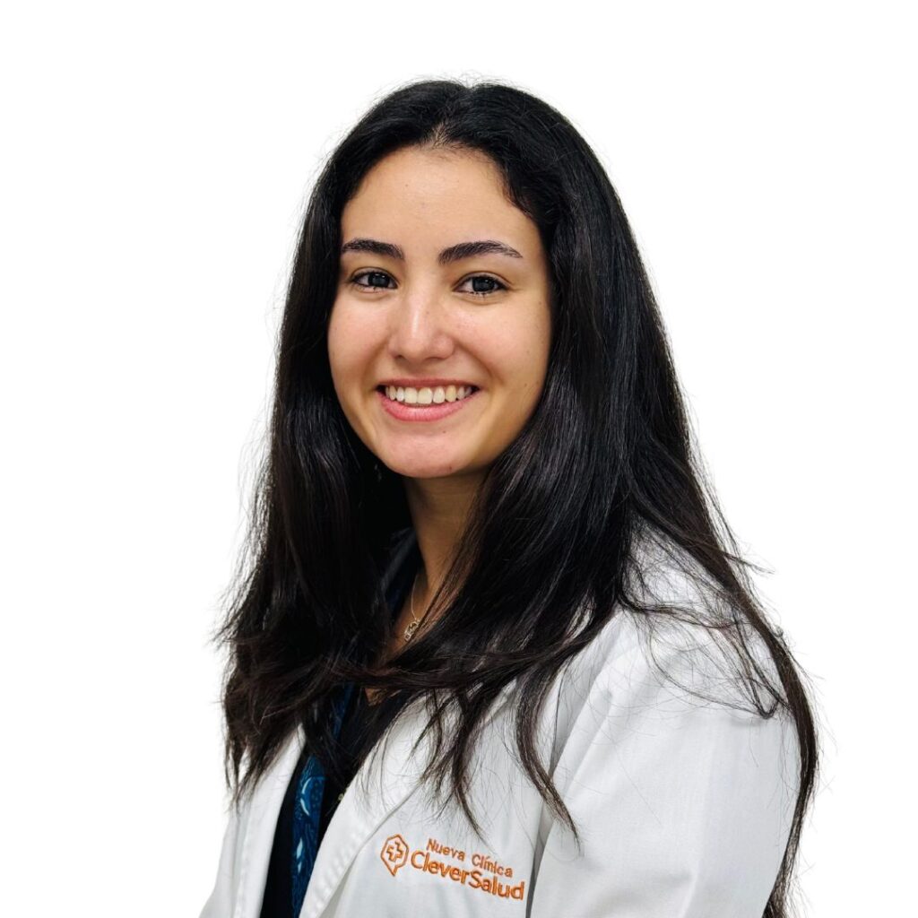 Smiling woman with long dark hair in a white lab coat featuring the Clever Salud logo.