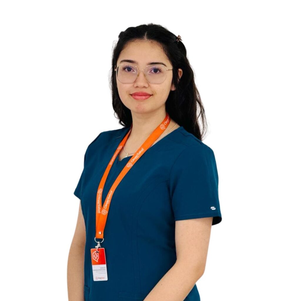 Portrait of a healthcare professional wearing teal scrubs and an orange lanyard with ID badge on white background.