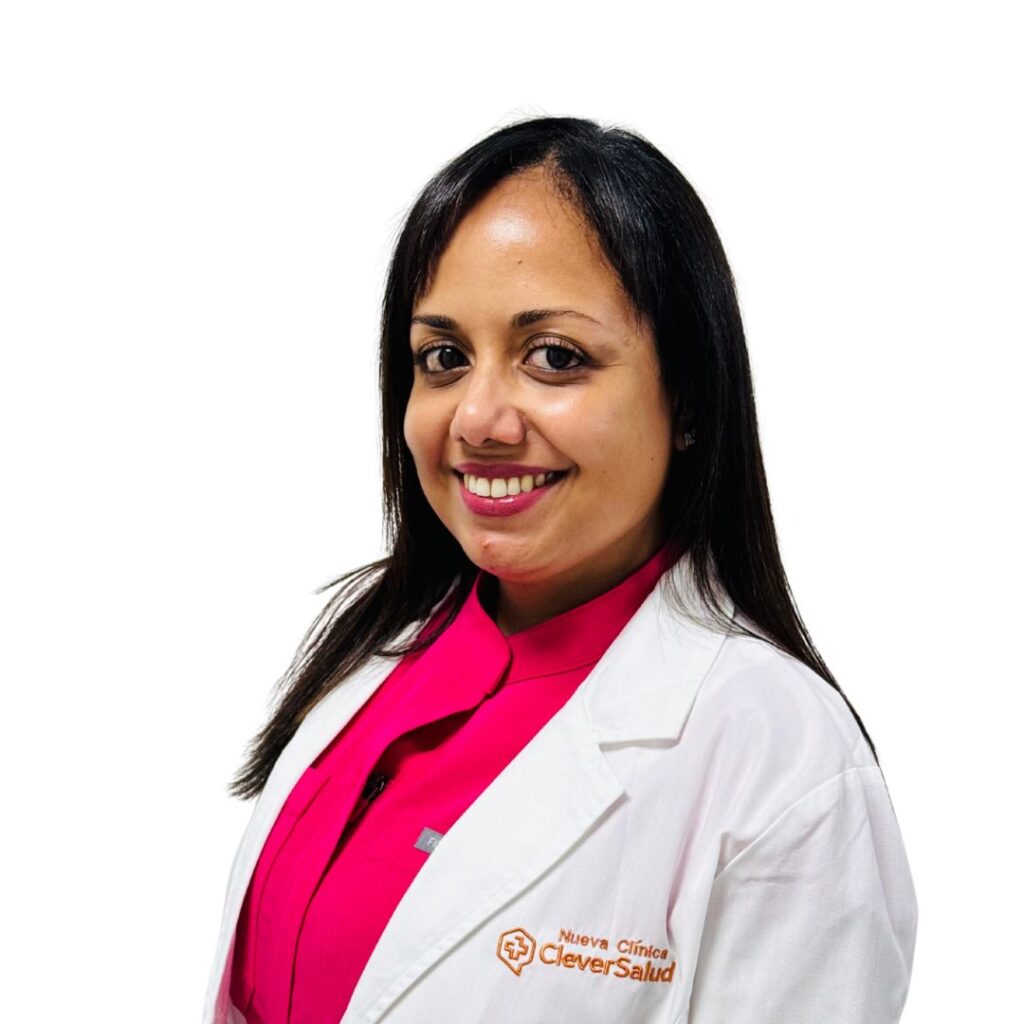 Smiling woman in a white lab coat over a bright pink blouse, healthcare professional photographed against a white background.