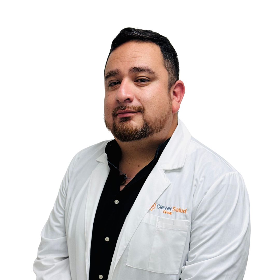Portrait of a man in a white lab coat over a black shirt, posing against a white background; Clever Salud Group logo visible on the pocket.