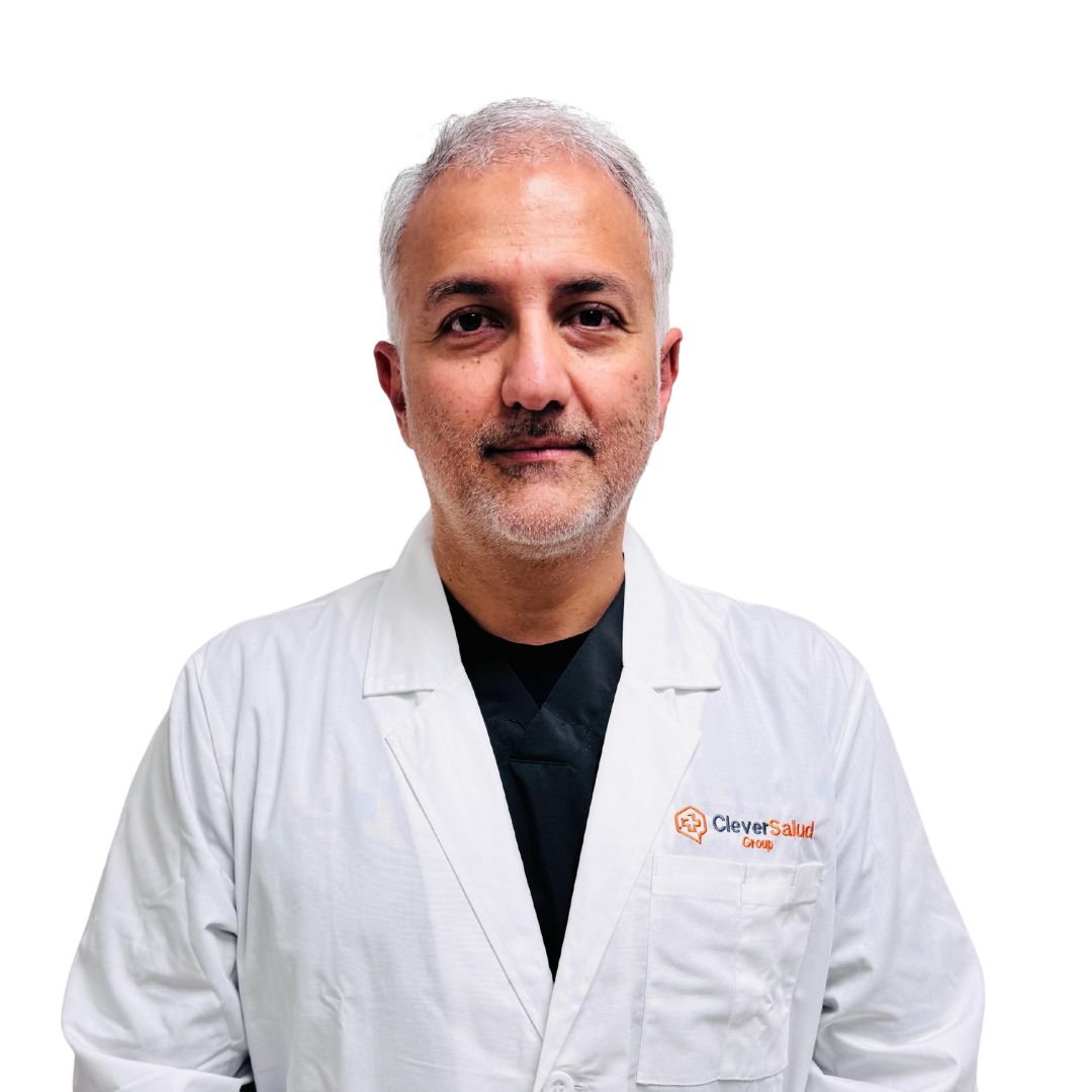 Male healthcare professional wearing a white lab coat with Clever Salud Group logo on the chest, against a white background.
