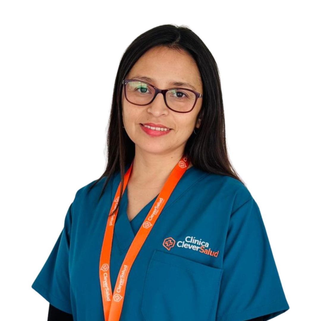 Female healthcare professional in teal scrubs with an orange lanyard, smiling at the camera.
