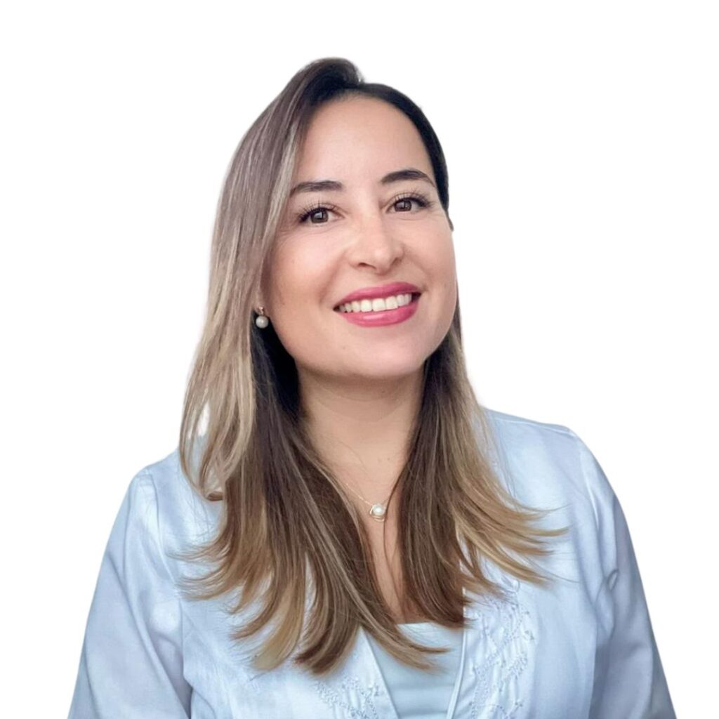 Portrait of a smiling woman with light brown, shoulder-length hair wearing a light blue blouse against a white background.
