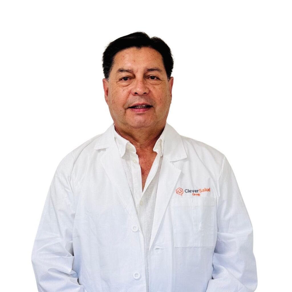 Male doctor in a white lab coat posing against a white background.