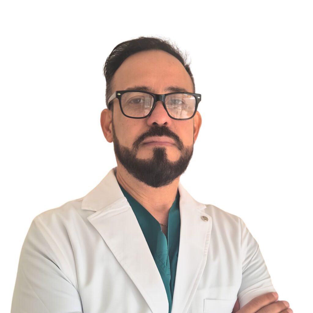 Portrait of a man with glasses and a white lab coat, arms crossed, looking at the camera against a white background