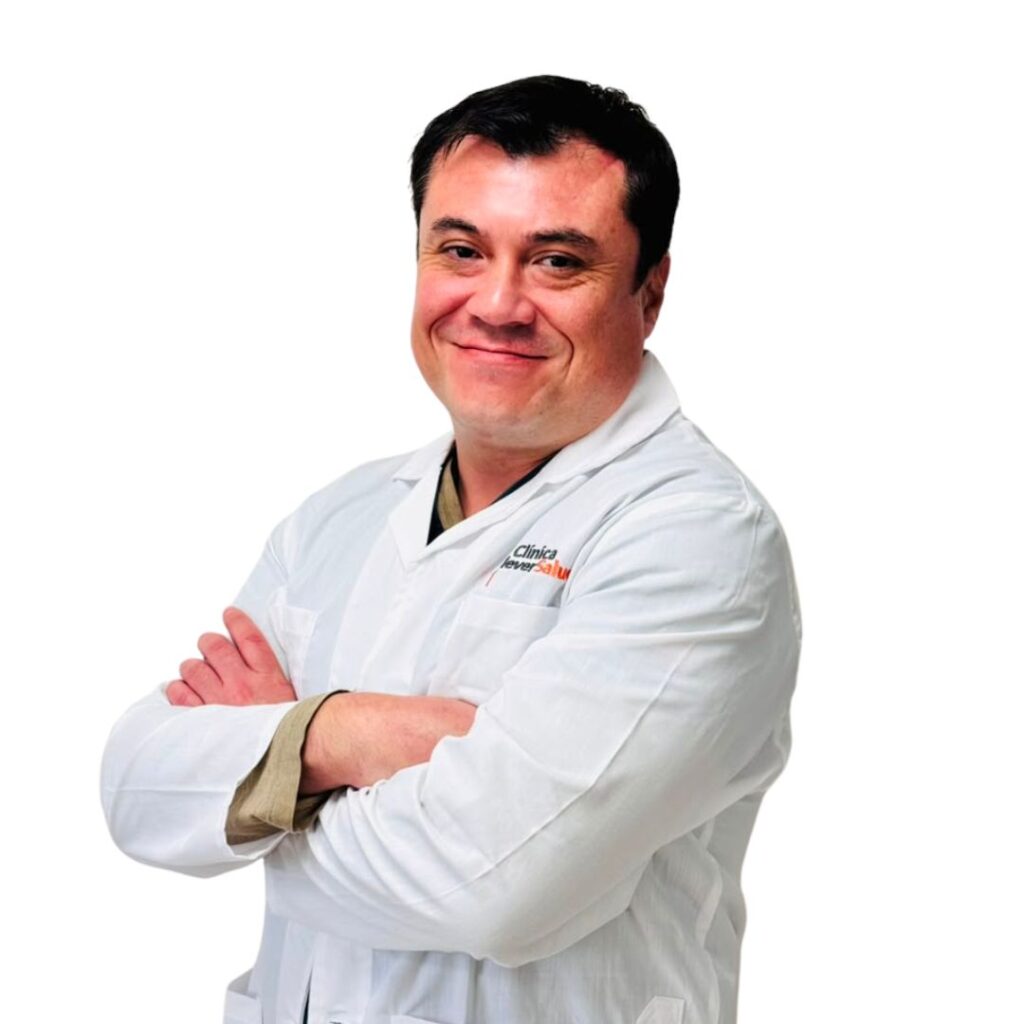 Smiling male healthcare professional in a white lab coat with arms crossed (portrait)