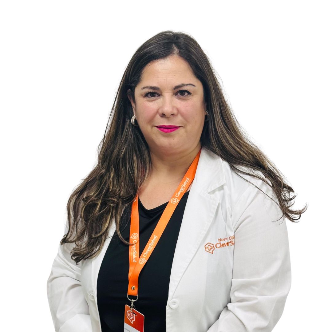 Woman in a white lab coat with an orange lanyard and ID badge, smiling for a portrait.