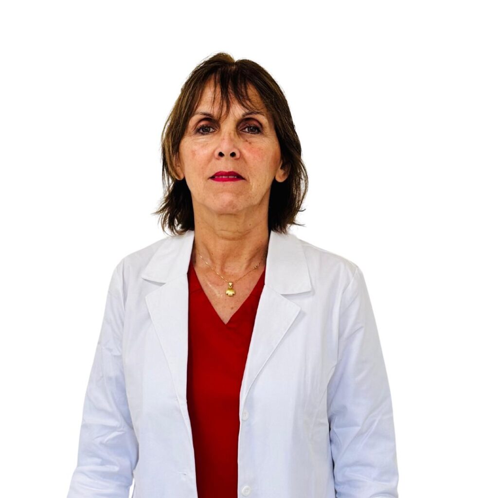 Female medical professional wearing a white lab coat over a red blouse, posed against a white background.